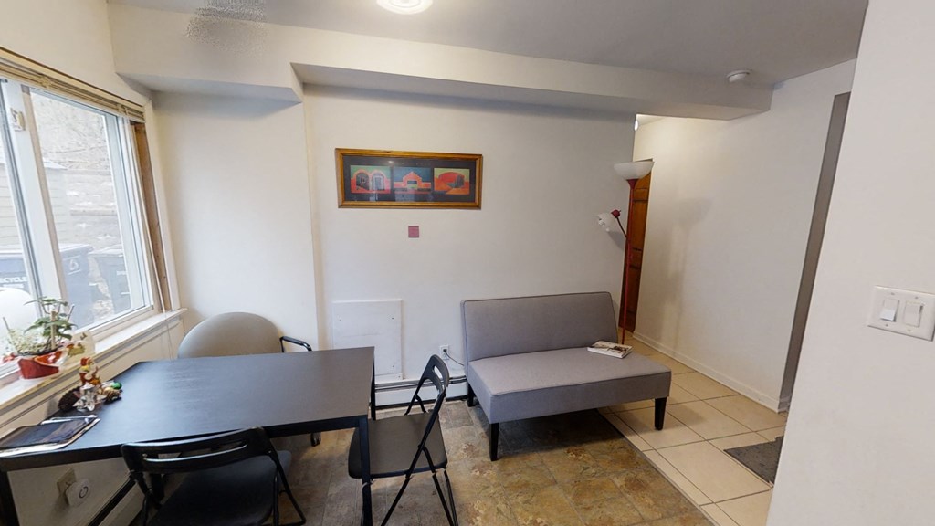 a dining room and living room with a table and a couch